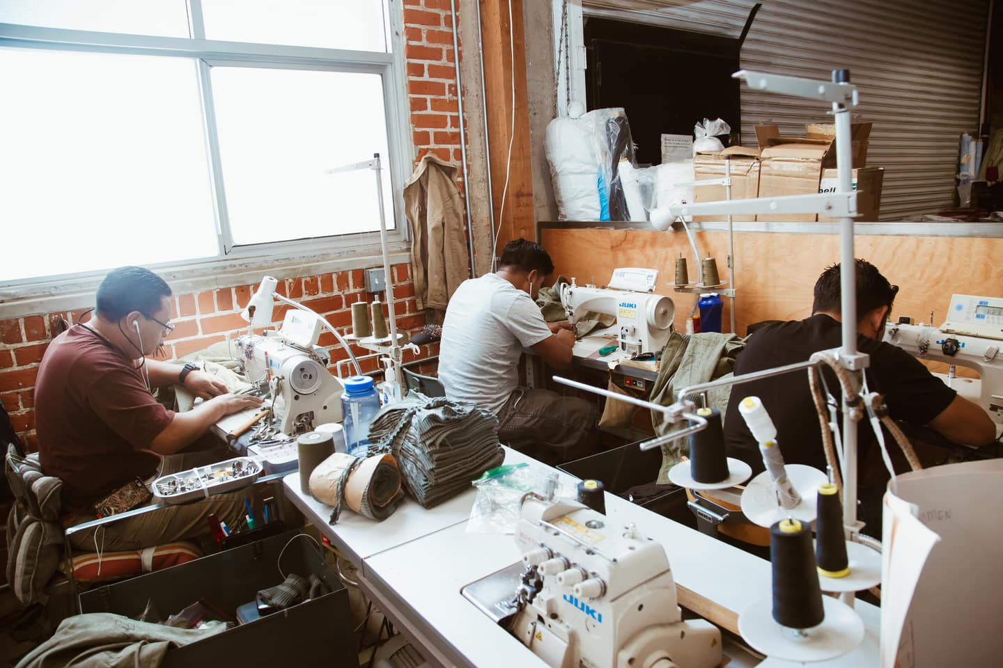 Three People Working in Clothing Manufacturing Office