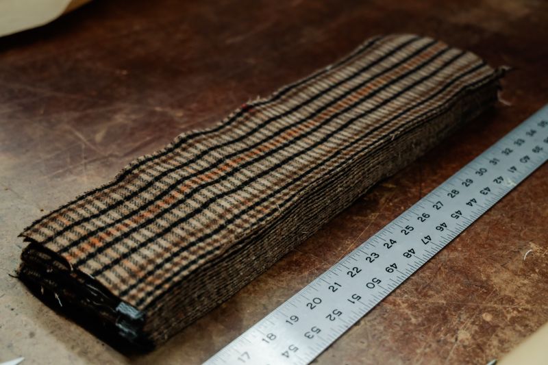 Measuring brown fabric for cutting