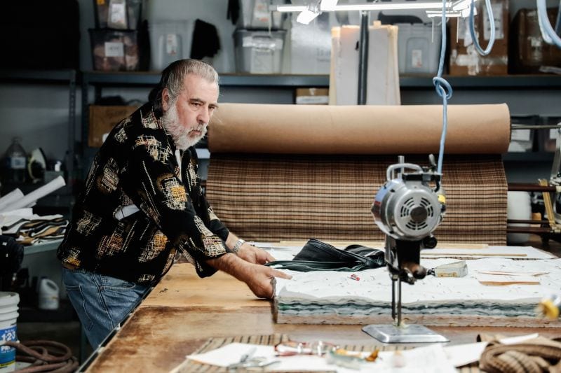 Man cutting fabric with tissue paper