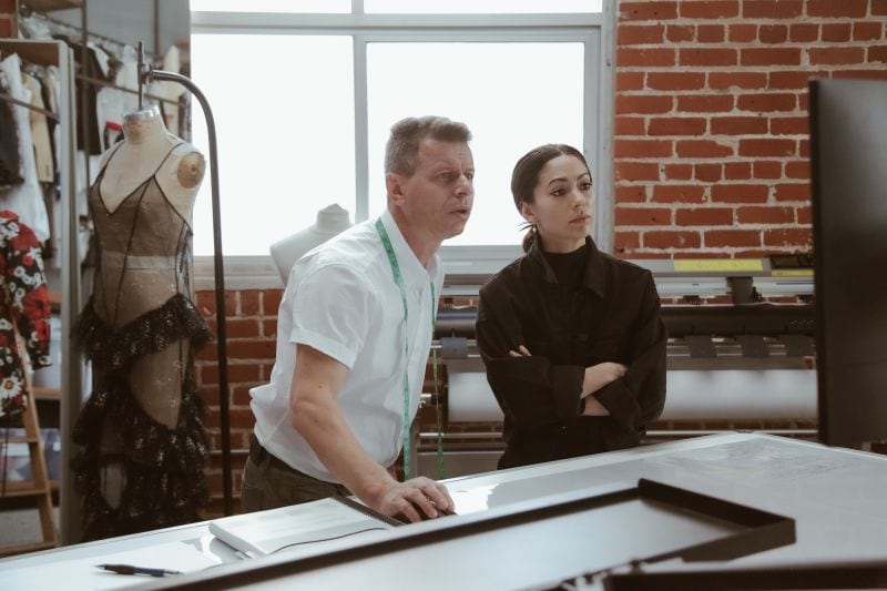 Pattern makers reviewing samples