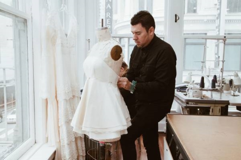 Designer putting a dress on a mannequin