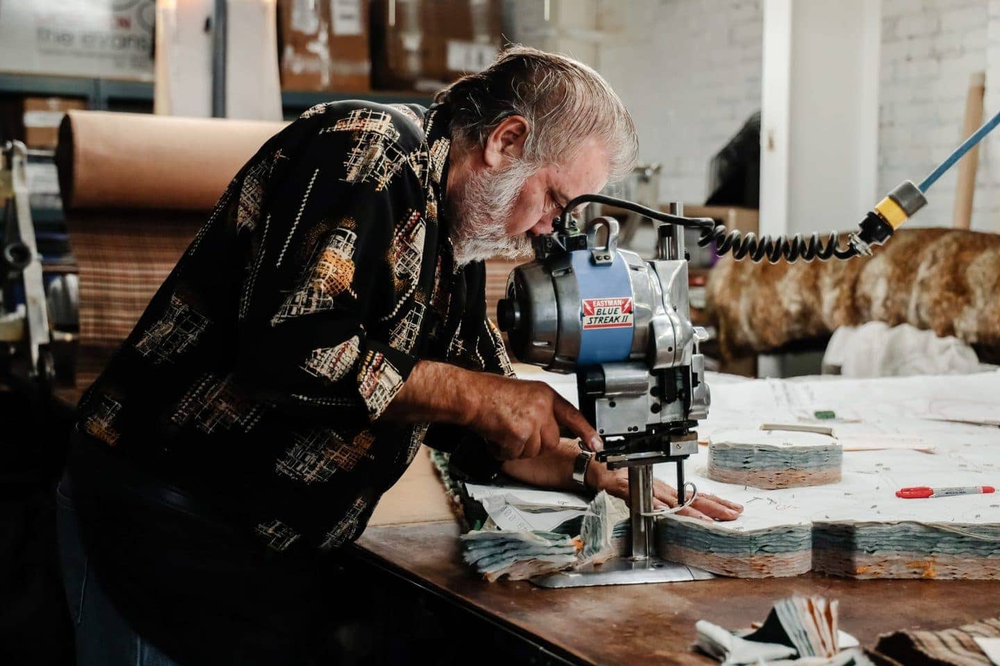 Man using a fabric cutting machine