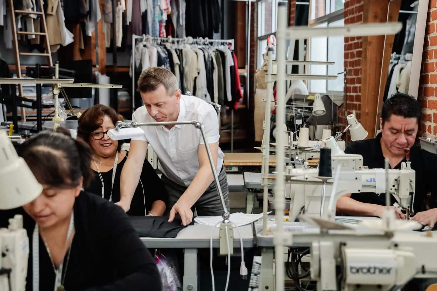 L.A. Clothing manufacturer going over pattern making with seamstresses