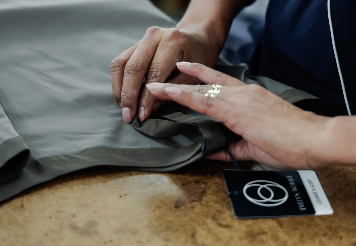Closeup of hands gathering fabric for a clothing line