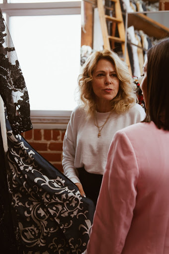 two clothing designers discussing dressmaking