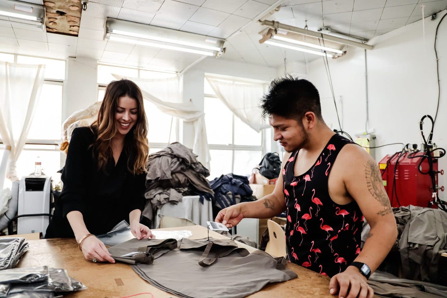 Two Los Angeles Clothing manufacturers going over the natural fibers in a new design