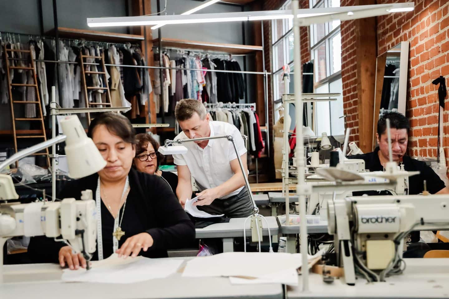 Team of clothing manufacturers working at sewing machines in the TEG Los Angeles clothing factory