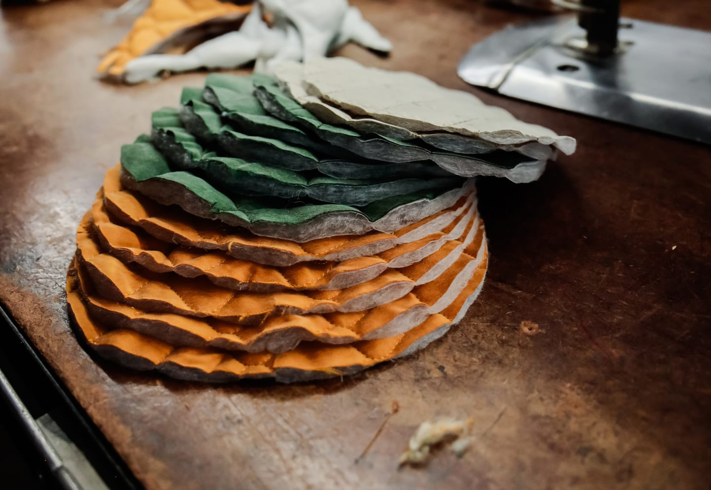 Stack of yellow and green sustainable fabric pieces before garment production