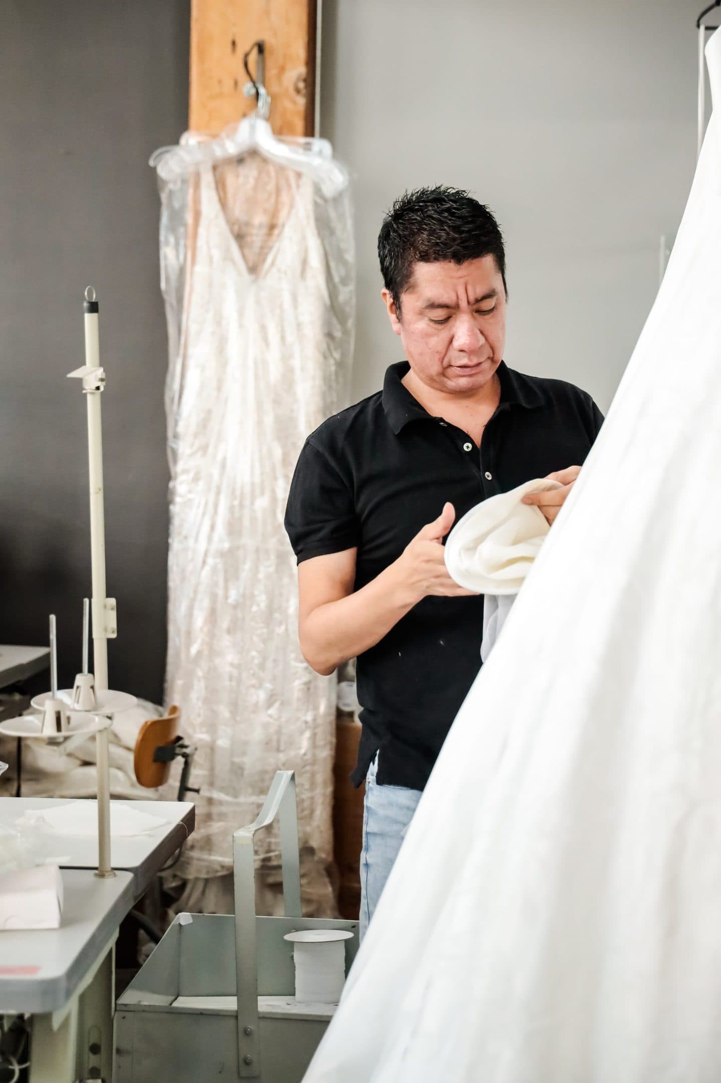 Clothing manufacturer attempting to avoid fashion mistakes while examining a wedding dress