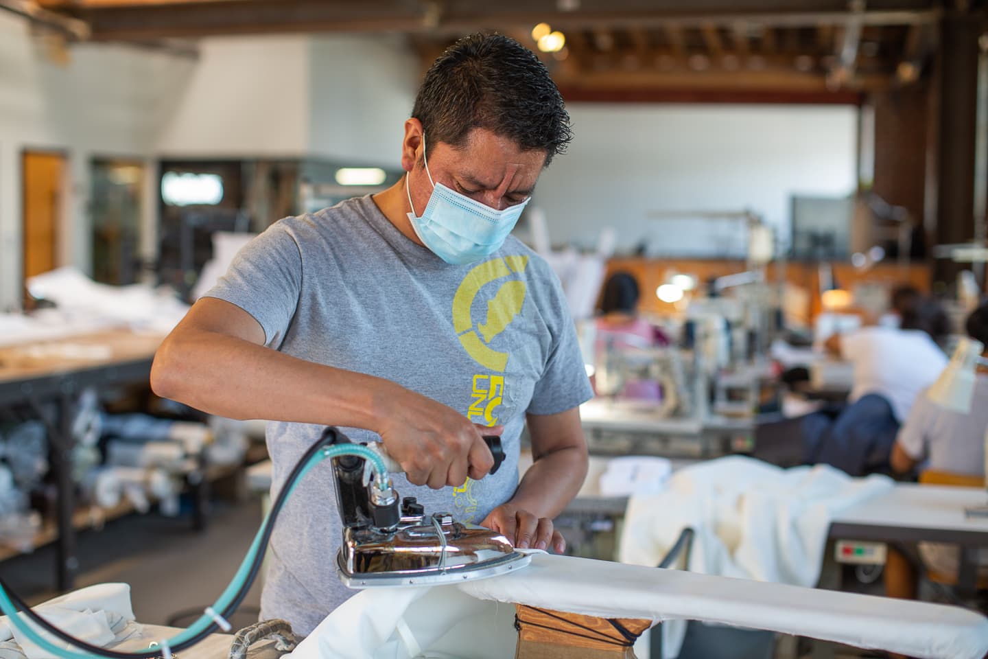 A Los Angeles pattern maker using an iron to help in pattern drafting