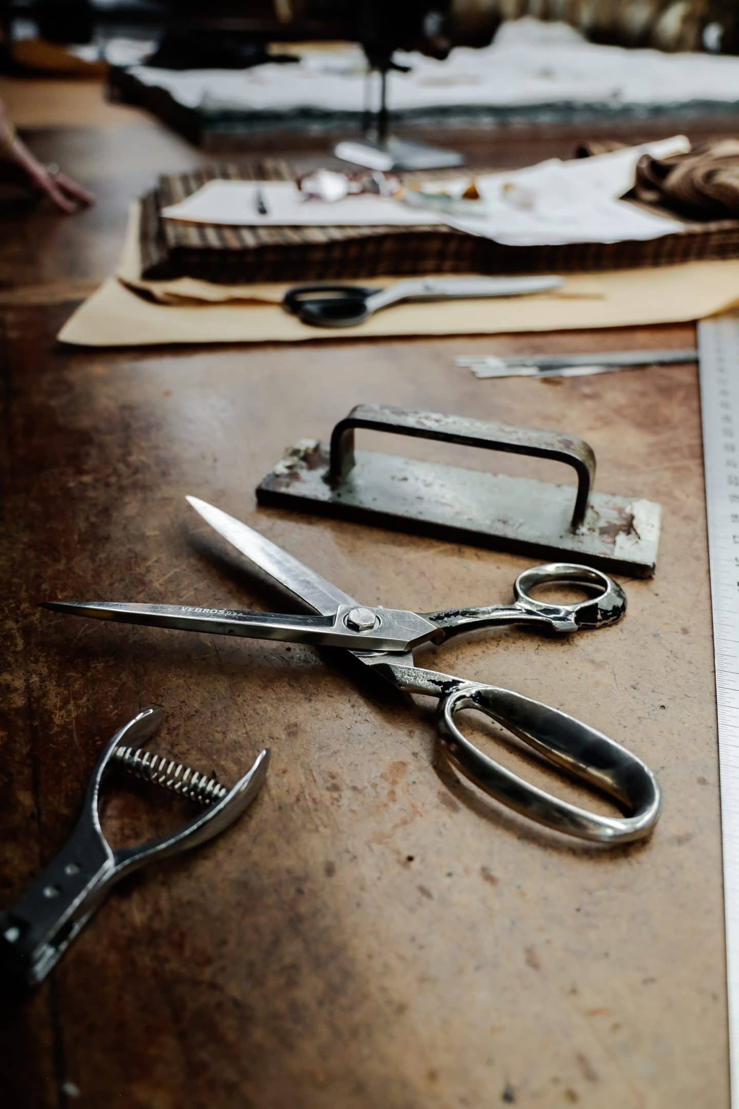 Assorted tools on a wooden table at a Los Angeles clothing manufacturing studio