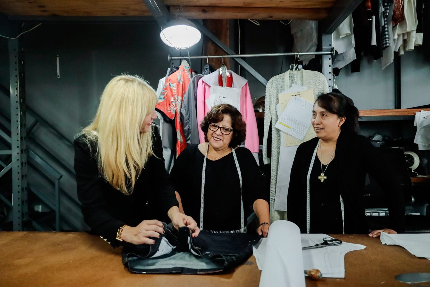 Jennifer Evans meeting with two seamstresses to discus Spring 2022 fashion trends