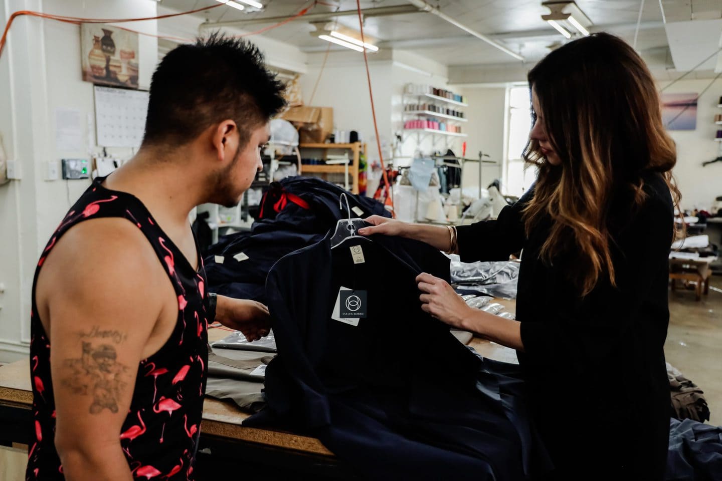 Two clothing manufacturers in Los Angeles examining sustainable clothing