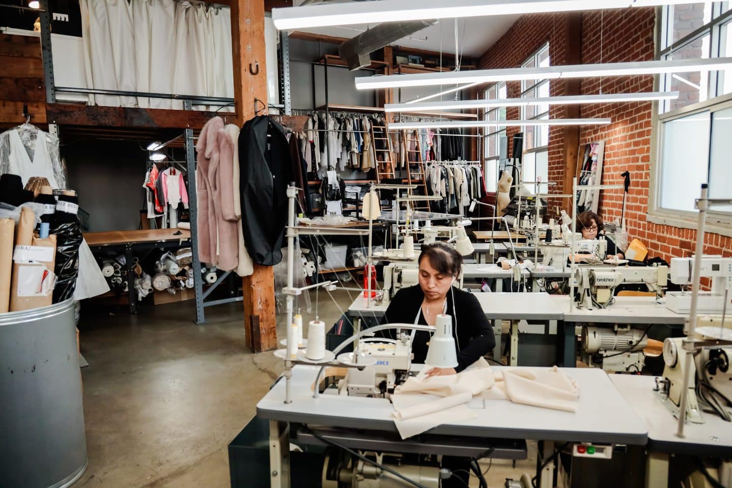 seamstress working at sewing table at a los angeles garment manufacturer