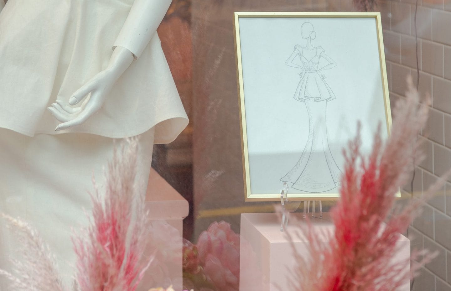mannequin standing next to a fashion drawing