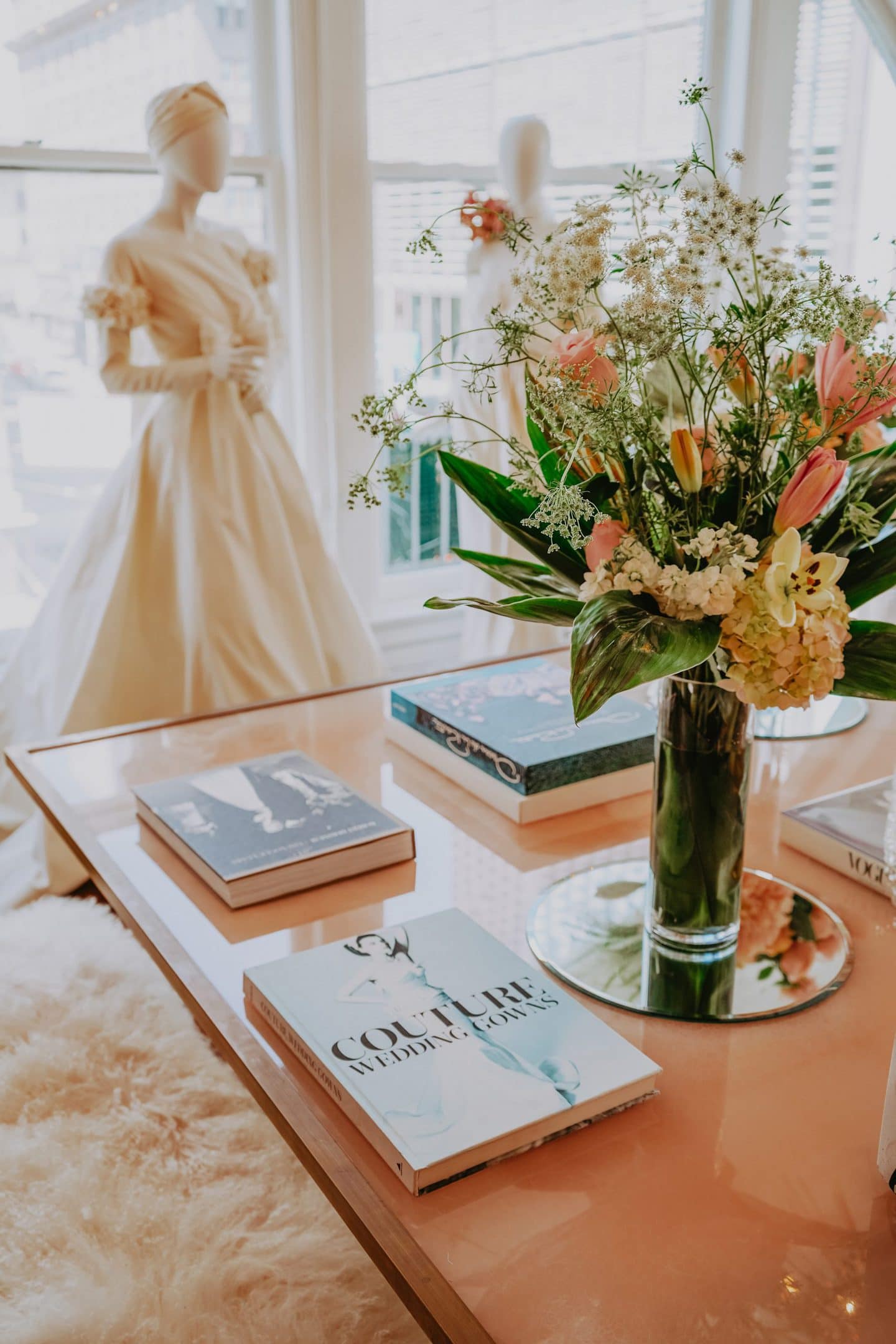 table with books in front of a mannequin