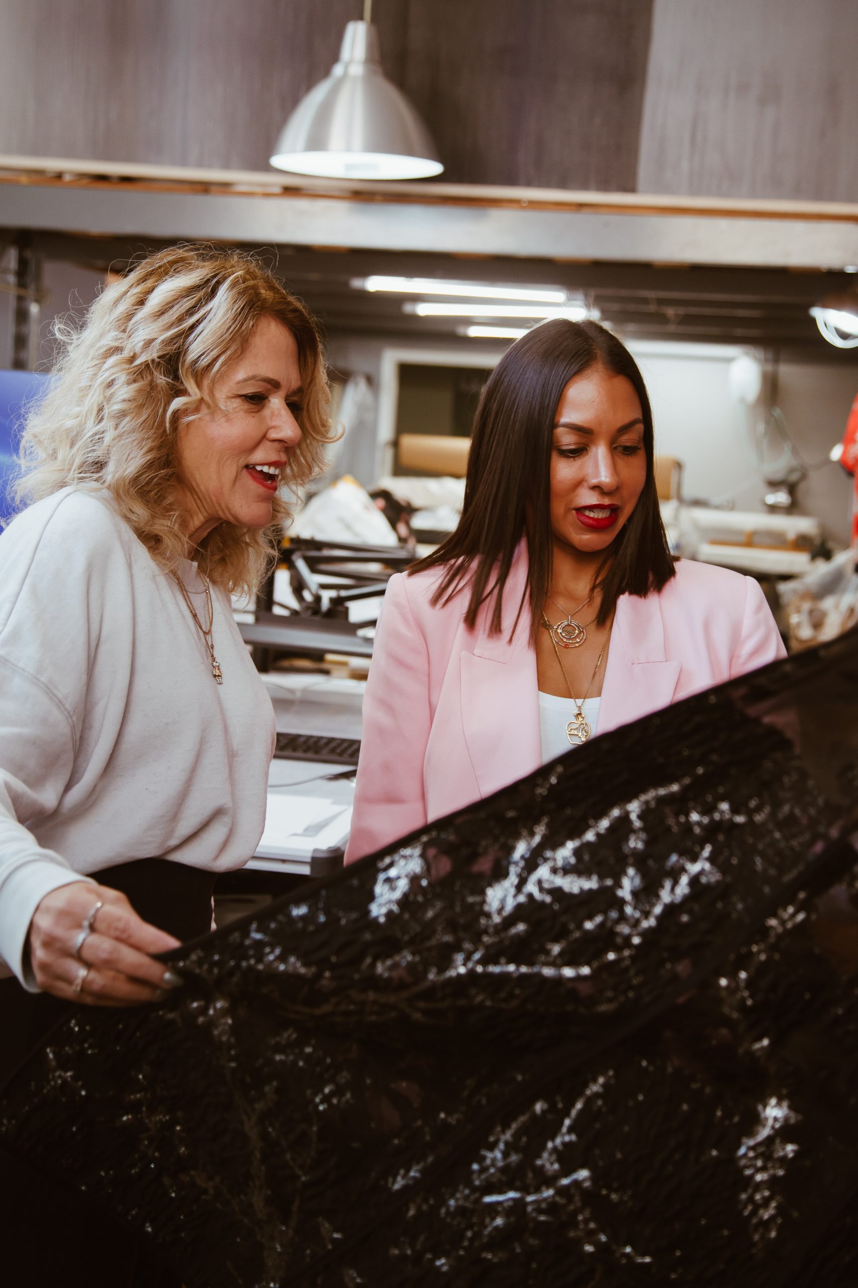 fashion consultant showing fashion designer a black dress