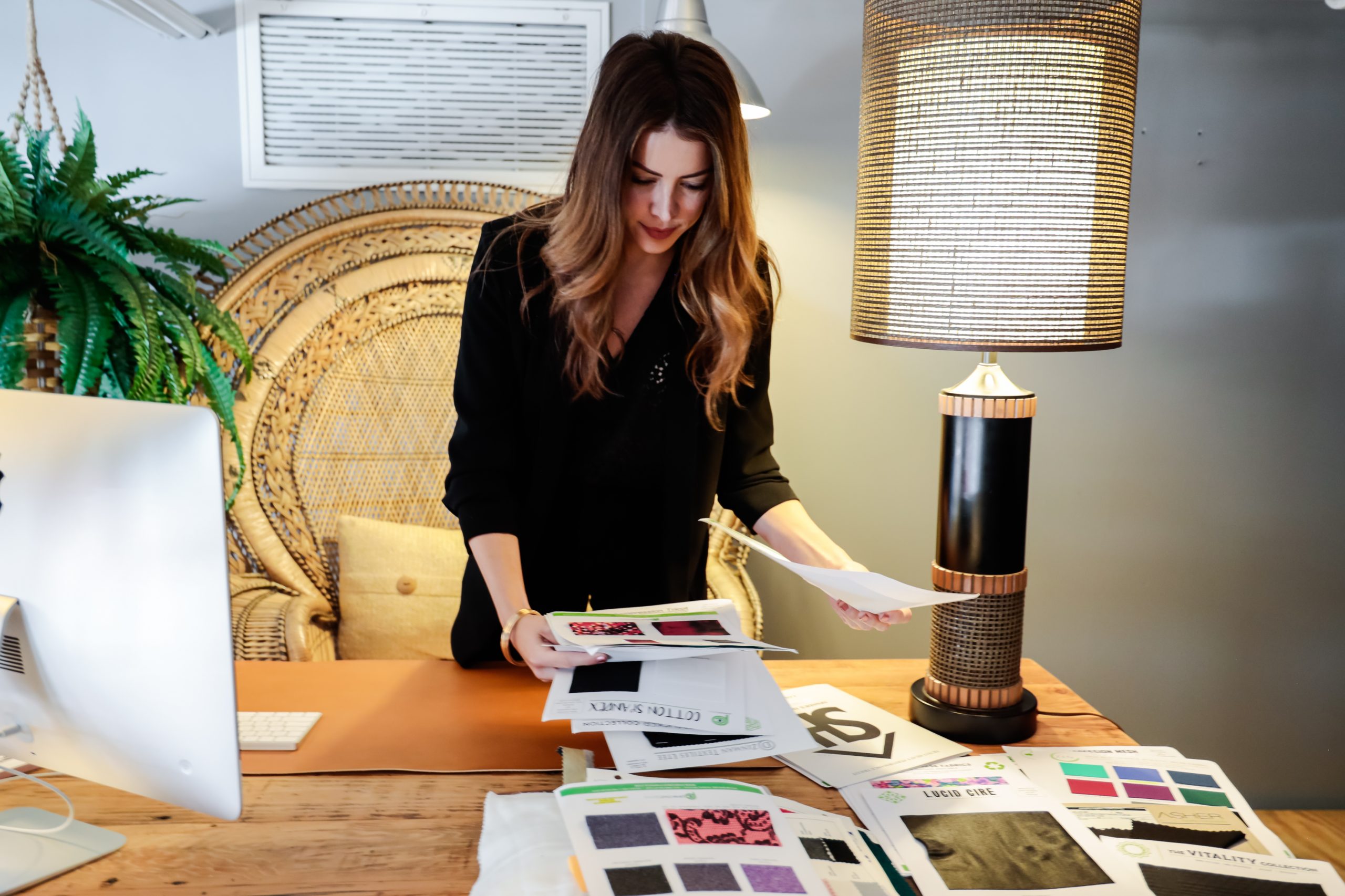 fashion designer in office looking at fashion papers