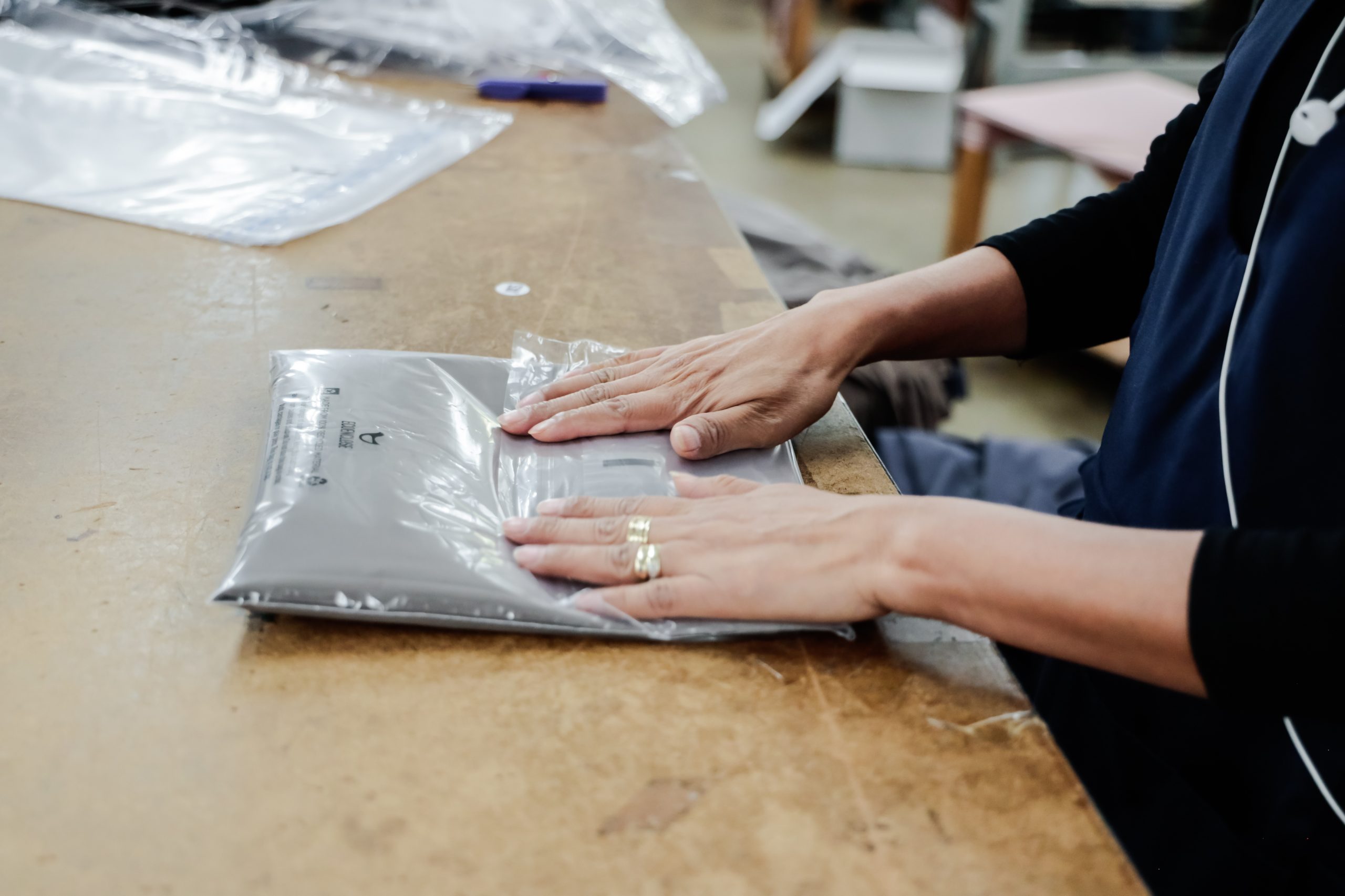 woman smoothing out plastic covering on clothing