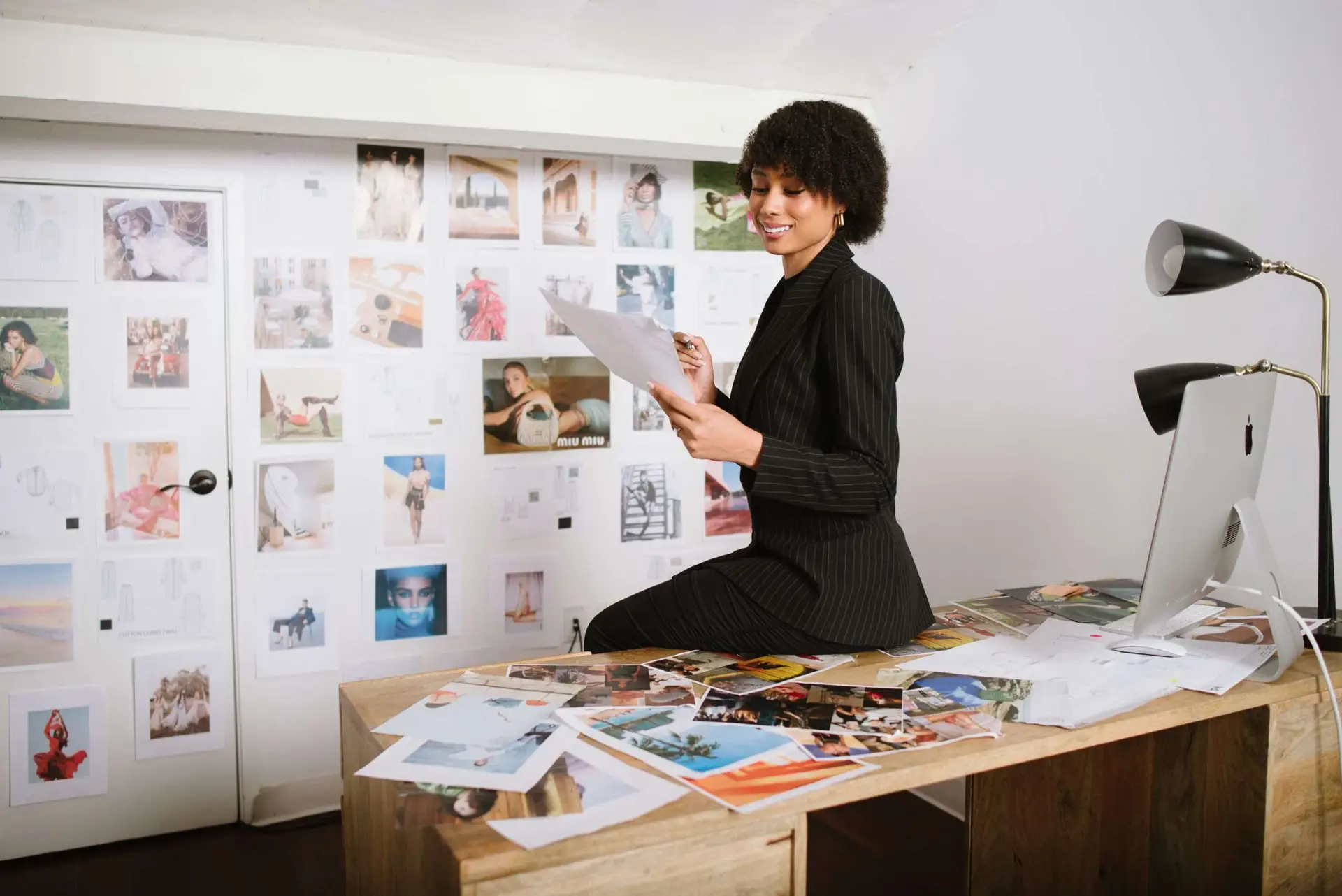 A woman reviews a fashion marketing strategy in her office.